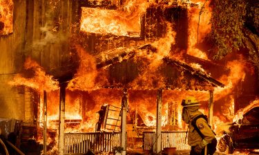 Fire consumes a home as the Sugar Fire