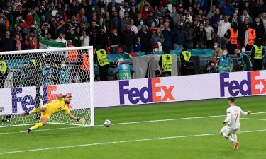 Italy's goalkeeper Gianluigi Donnarumma stops a penalty shot from Spain's Alvaro Morata during the semifinal match between Italy and Spain in London