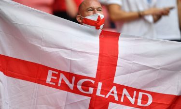 An England supporter waves a flag ahead of the start of the Euro 2020 match between England and Germany.