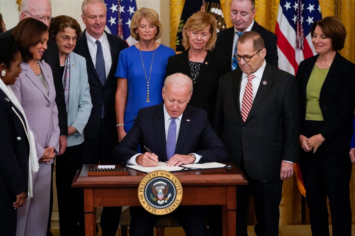 <i>Andrew Harnik/AP</i><br/>President Joe Biden signs H.R. 1652