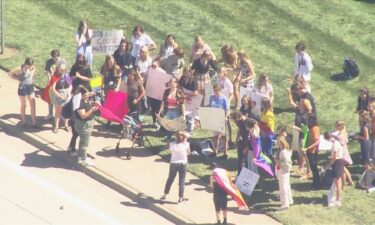 About 30 students walked out of class on to support a coach who says he was forced to resign for being gay. They say they also want to see significant changes to the school's policies and culture.