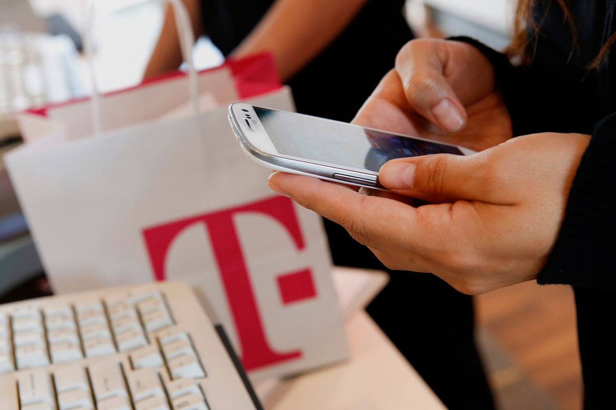 <i>Patrick T. Fallon/Bloomberg/Getty Images</i><br/>An employee sets up a new Samsung  Electronics Co. Galaxy 3 smartphone for a customer at a T-Mobile US Inc. retail store in Torrance