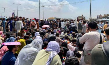 Afghan people gather outside Kabul's airport on Friday.