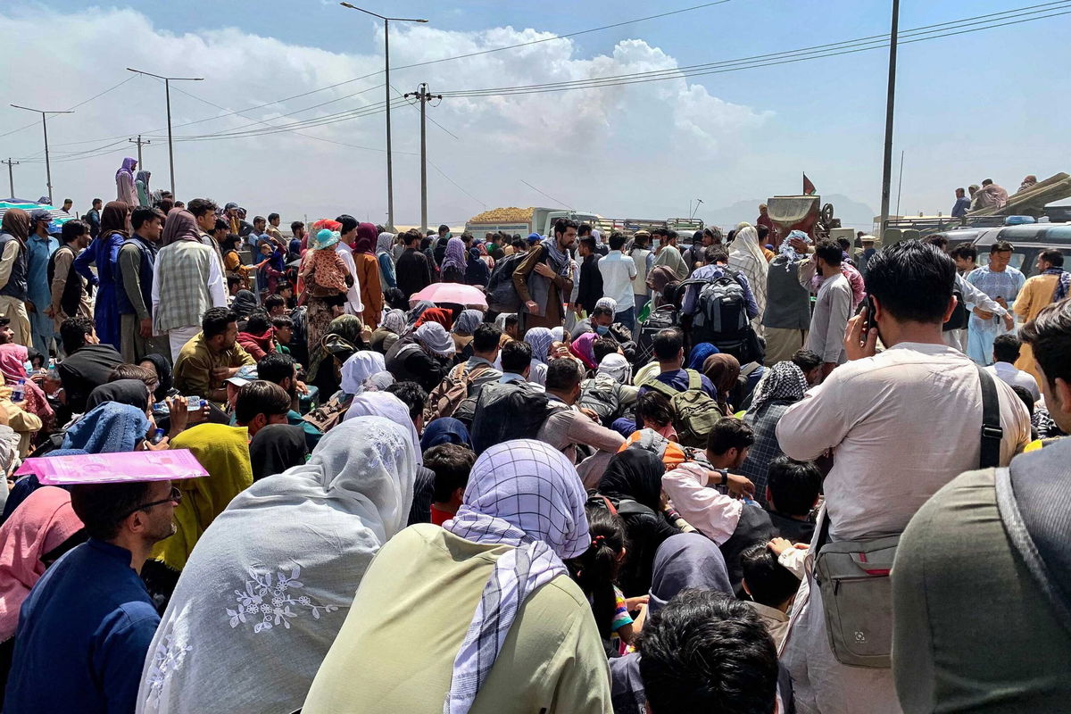 <i>Wakil Kohsar/AFP/Getty Images</i><br/>Afghan people gather outside Kabul's airport on Friday.