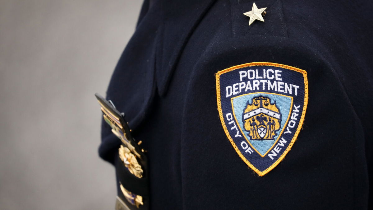 <i>Drew Angerer/Getty Images</i><br/>An NYPD officer arrives for the funeral service of fallen NYPD Detective Brian Simonsen at the Church of St. Rosalie