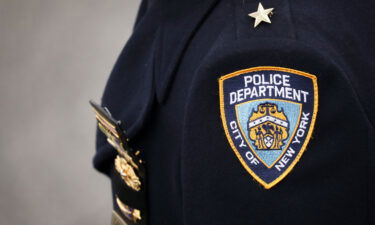 An NYPD officer arrives for the funeral service of fallen NYPD Detective Brian Simonsen at the Church of St. Rosalie