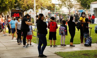 Filtered or fresh air is another way to help protect students from breathing in the virus. Parents and students here form lines outside Lankershim Elementary School in North Hollywood on August 17.