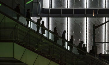 China is putting companies that overwork their employees on notice. People are seen here in the Lujiazui financial district in Shanghai