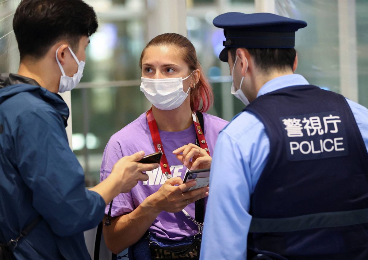 <i>Issei Kato/Reuters</i><br/>Belarusian athlete Kristina Timanovskaya talks with police at Haneda international airport in Tokyo on August 1.
