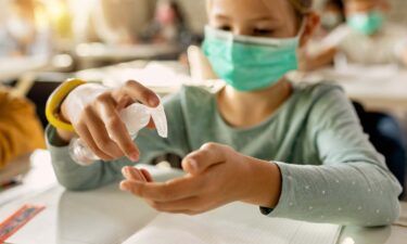 A close-up is shown of elementary student disinfecting hands in the classroom due to Covid-19 pandemic. More kids were hospitalized with Covid-19 this month than any other time this past year -- further proving how seriously the Delta variant can hit any age group.