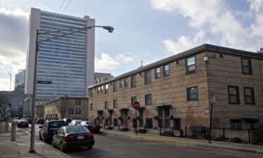 The Cabrini-Green rowhouses stand in front of a residential tower in Chicago in 2018. Cook County