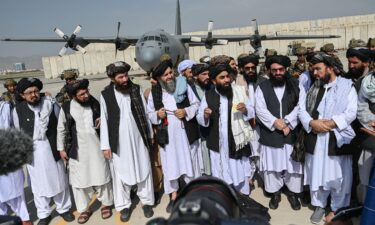 Taliban spokesman Zabihullah Mujahid speaks to the media at the Kabul airport.