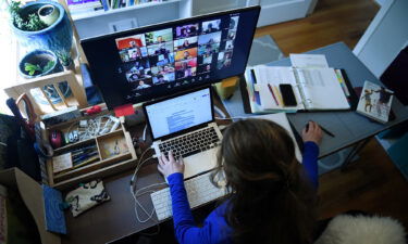 Shares of Zoom plunged more than 15% Tuesday morning. Pictured is a school teacher working from her home due to the Coronavirus outbreak on April 1