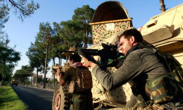 Afghan security personnel take a position during fighting between Taliban and Afghan security forces in Herat province