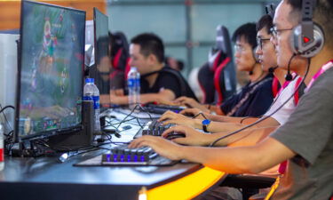 China bans kids from playing online video games during the week. Pictured are gamers at the Shanghai New International Expo Center on Aug. 1