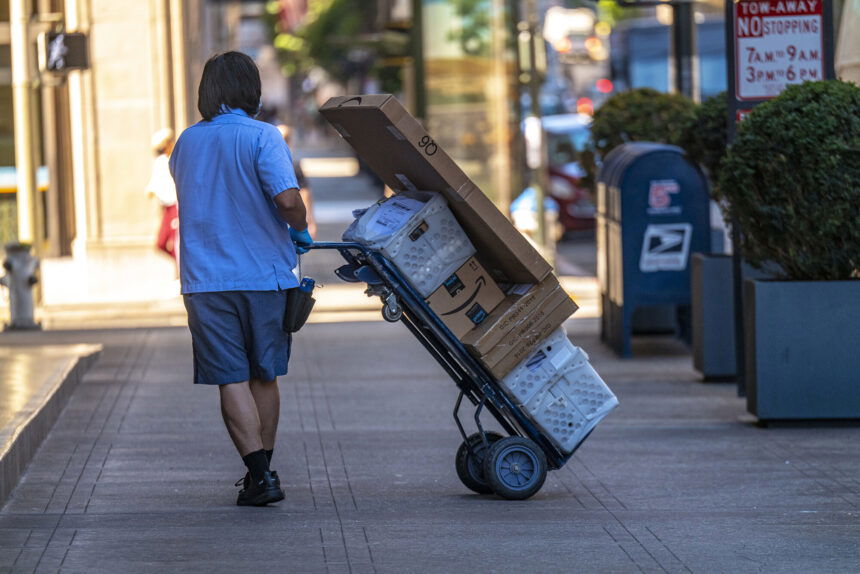 Online prices jumped 3.1% year-over-year in July. A U.S. Postal Service worker makes a delivery in San Francisco