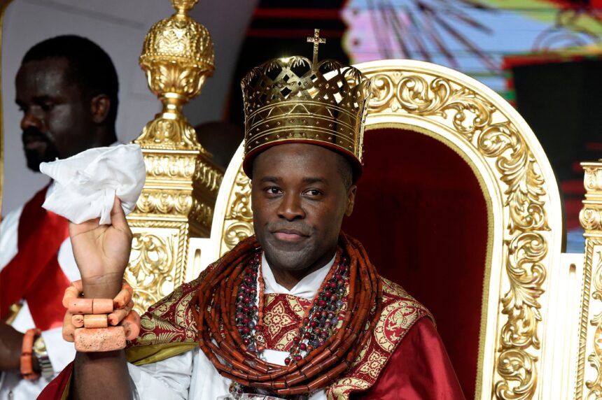 Prince Tsola Emiko waves after being crowned as the 21st king or the Olu of Warri kingdom and the Ogiame Atuwatse III during his coronation at Ode-Itsekiri on August 21.