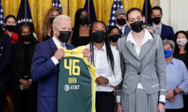 President Joe Biden accepts a jersey on Monday