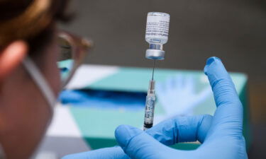 A syringe is filled with a first dose of the Pfizer Covid-19 vaccine at a mobile vaccination clinic in Los Angeles