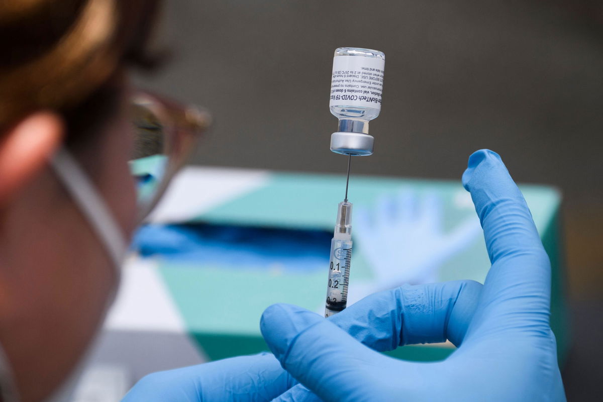 A syringe is filled with a first dose of the Pfizer Covid-19 vaccine at a mobile vaccination clinic in Los Angeles, California.