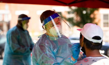 A healthcare worker administers a Covid-19 test at a testing site in Mifflin Square Park in Philadelphia Thursday.