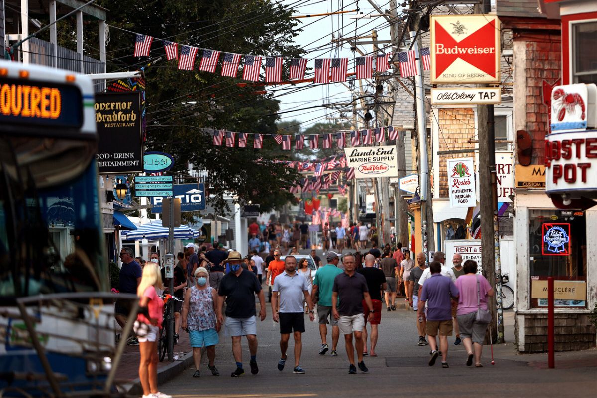 <i>Barry Chin/The Boston Globe/Getty Images</i><br/>A Covid-19 outbreak in Provincetown helped change the CDC's mask guidance. People walk down Commercial Street in Provincetown on Tuesday
