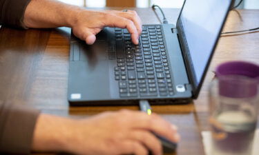 A person uses a laptop computer while working from home in Princeton