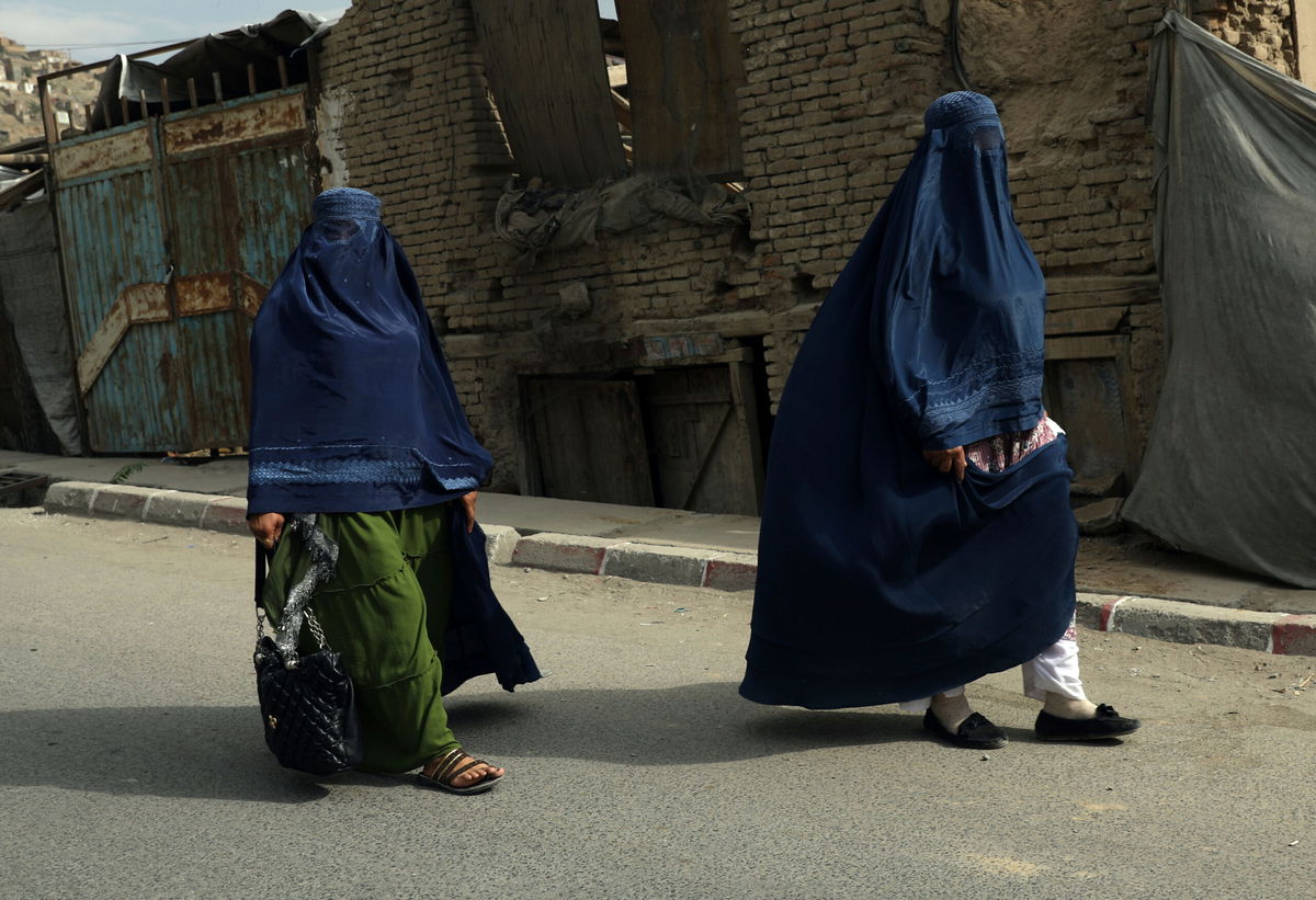 <i>Rahmat Gul/AP</i><br/>Taliban told working women to stay at home because soldiers are 'not trained' to respect them. Afghan women in burqas here walk on a street in Kabul