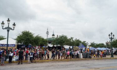 A Federal appeals court Thursday ordered the Biden administration to reinstate former President Donald Trump's 'remain in Mexico' policy.  Migrants here line up for food in a camp in Reynosa