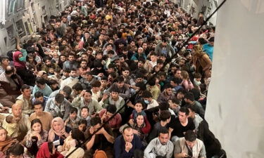 Afghan citizens pack inside a U.S. Air Force C-17 Globemaster III as they are transported from Hamid Karzai International Airport in Afghanistan