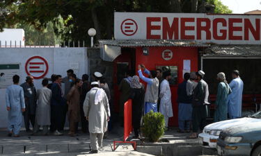 People gather to check on missing relatives on Friday.