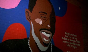 A mural of the actor Michael K. Williams overlooks a subway entrance in Brooklyn