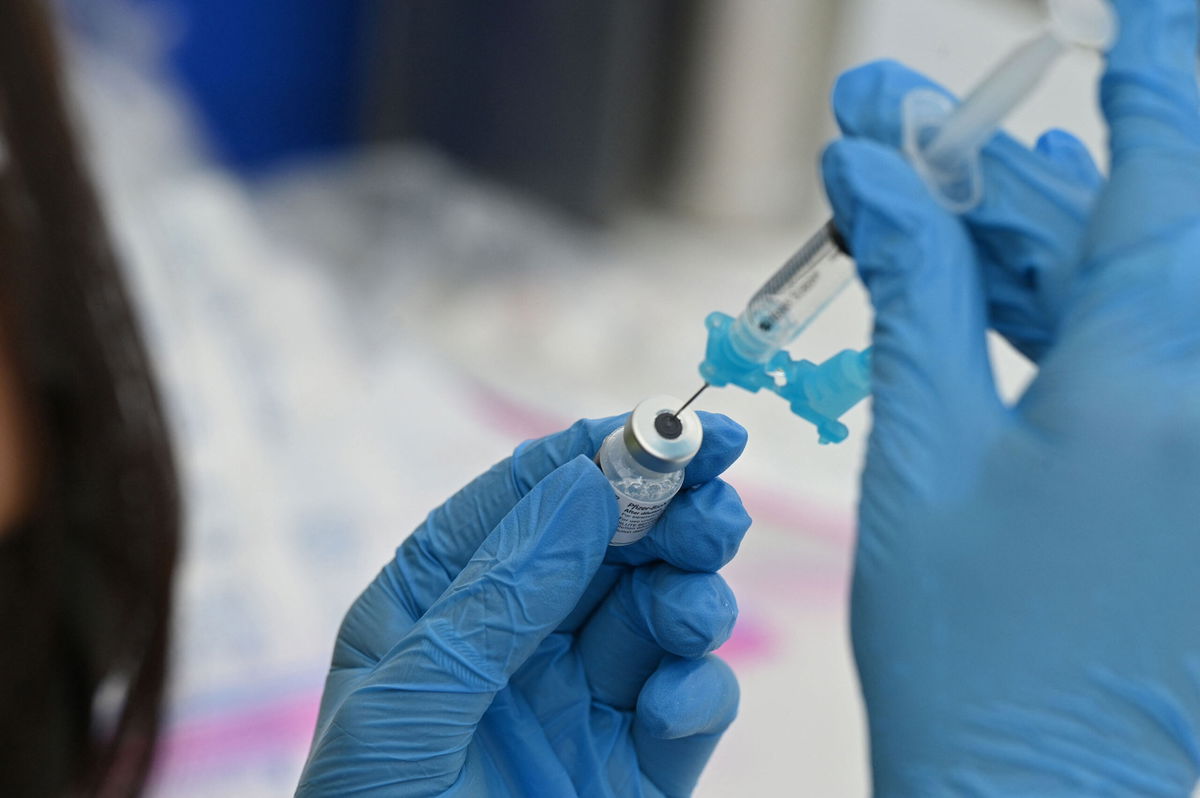 <i>ROBYN BECK/AFP/Getty Images</i><br/>A healthcare worker fills a syringe with Pfizer Covid-19 vaccine at a community vaccination event in a predominately Latino neighborhood in Los Angeles