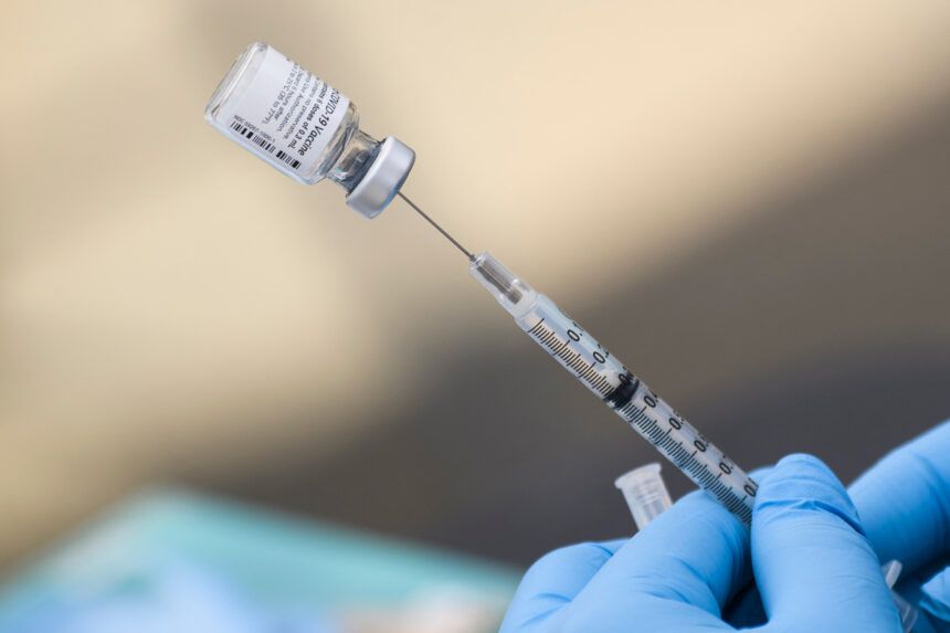 A syringe is filled with a first dose of the Pfizer Covid-19 vaccine at a mobile vaccination clinic during a back-to-school event offering school supplies