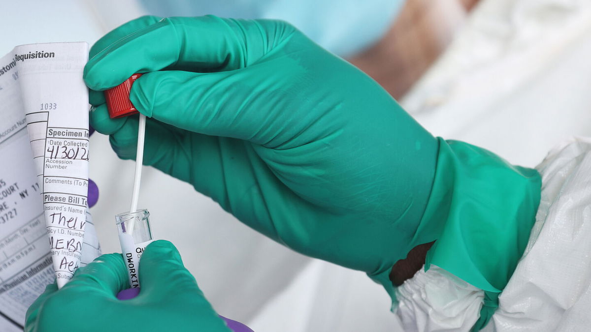 <i>Al Bello/Getty Images</i><br/>Long Covid is a bigger problem than we thought. A Health Care Worker seals a coronavirus test swab.