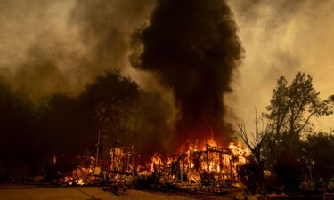 Flames consume a house as the Fawn Fire burns north of Redding on September 23.