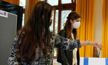 A woman casts her ballot for the abortion referendum at a polling station in San Marino