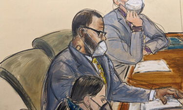 R. Kelly sits with his defense attorneys Thomas Farinella