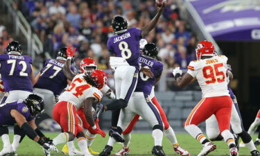 Jackson throws a touchdown while in midair against the Chiefs.