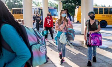Students arrive by bus for the first day of school at Kernodle Middle School in Greensboro