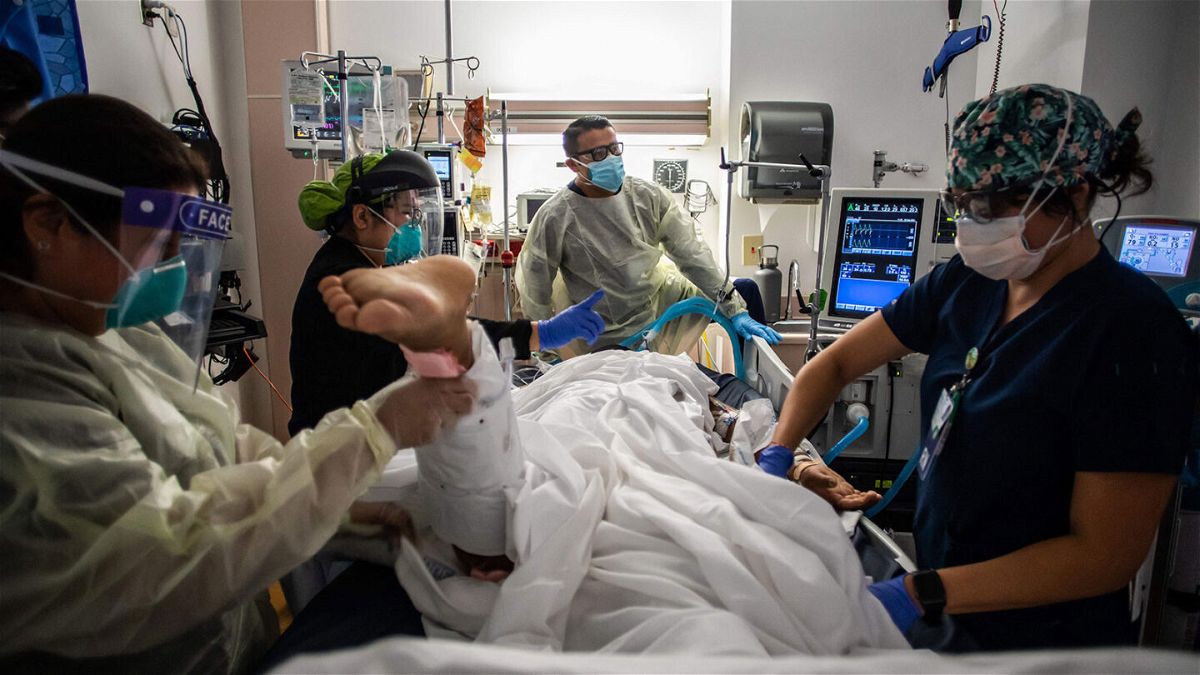 <i>Apu Gomes/AFP/Getty Images</i><br/>Health care workers attend to a patient with Covid-19 at the Cardiovascular Intensive Care Unit at Providence Cedars-Sinai Tarzana Medical Center in Tarzana