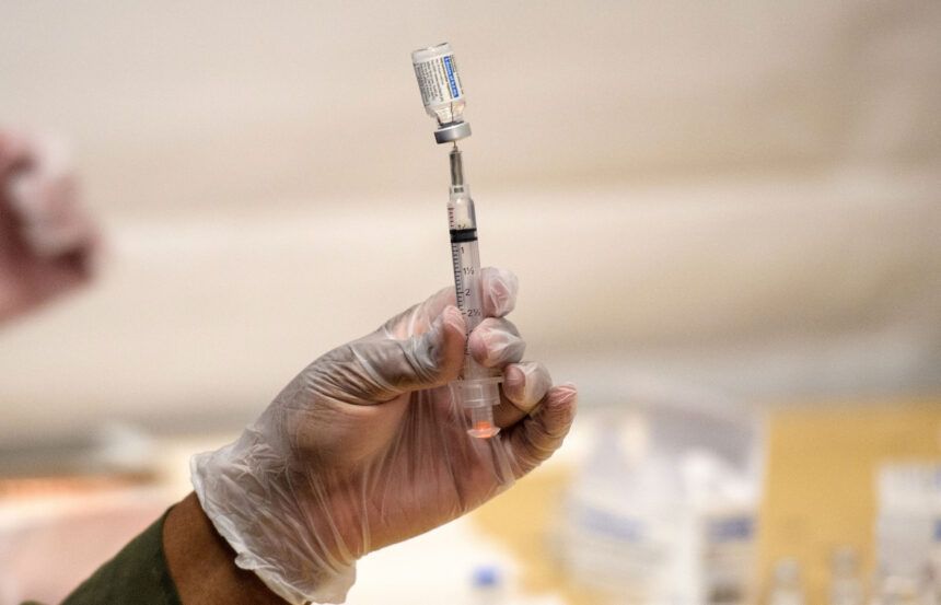 A healthcare worker prepares a syringe with a vial of the J&J/Janssen Covid-19 vaccine at a temporary vaccination site at Grand Central Terminal train station on May 12 in New York City.