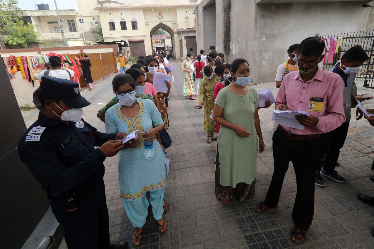 <i>Vishal Bhatnagar/NurPhoto/Getty Images</i><br/>Security personnel frisk a test candidate about to take the Rajasthan Eligibility Exam for Teachers (REET) at an examination center in Jaipur
