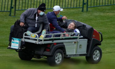 Felton is carted off the course.