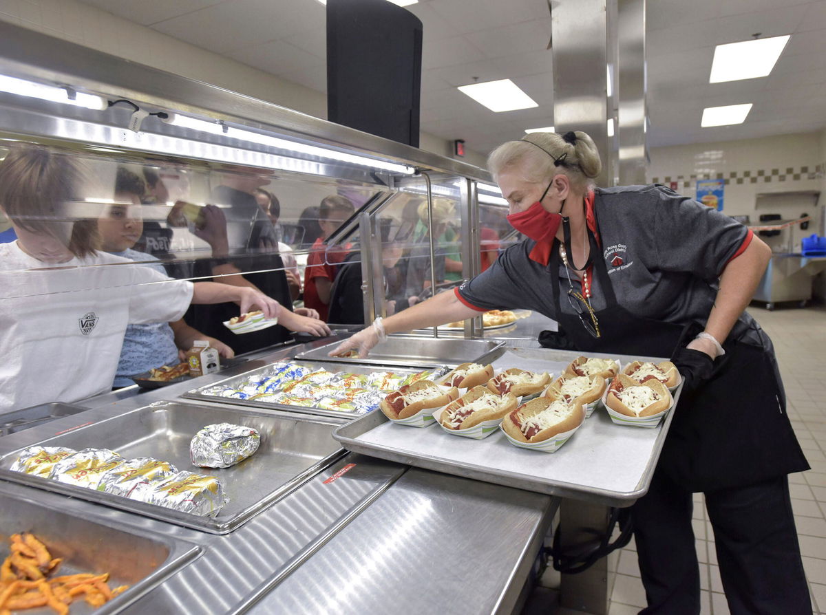 <i>Tony Giberson/USA Today Network</i><br/>Laura Vance puts out some food items on the lunch line in the Sims Middle School cafeteria in Pace