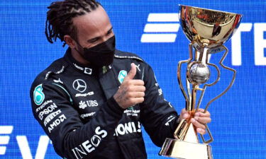 Hamilton celebrates on the podium after winning the Russian Grand Prix.