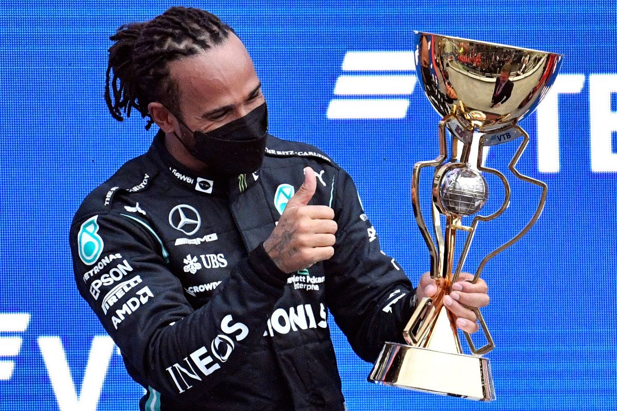 <i>Alexander Nemenov/AFP/Getty Images</i><br/>Hamilton celebrates on the podium after winning the Russian Grand Prix.