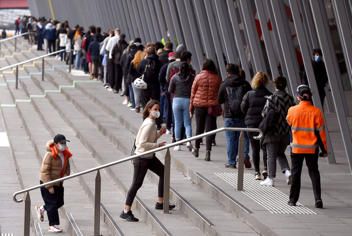 <i>WILLIAM WEST/AFP/Getty Images</i><br/>People form long queues outside a vaccination center in Melbourne on Aug. 27. Australia is on track to allow borders to reopen by Christmas