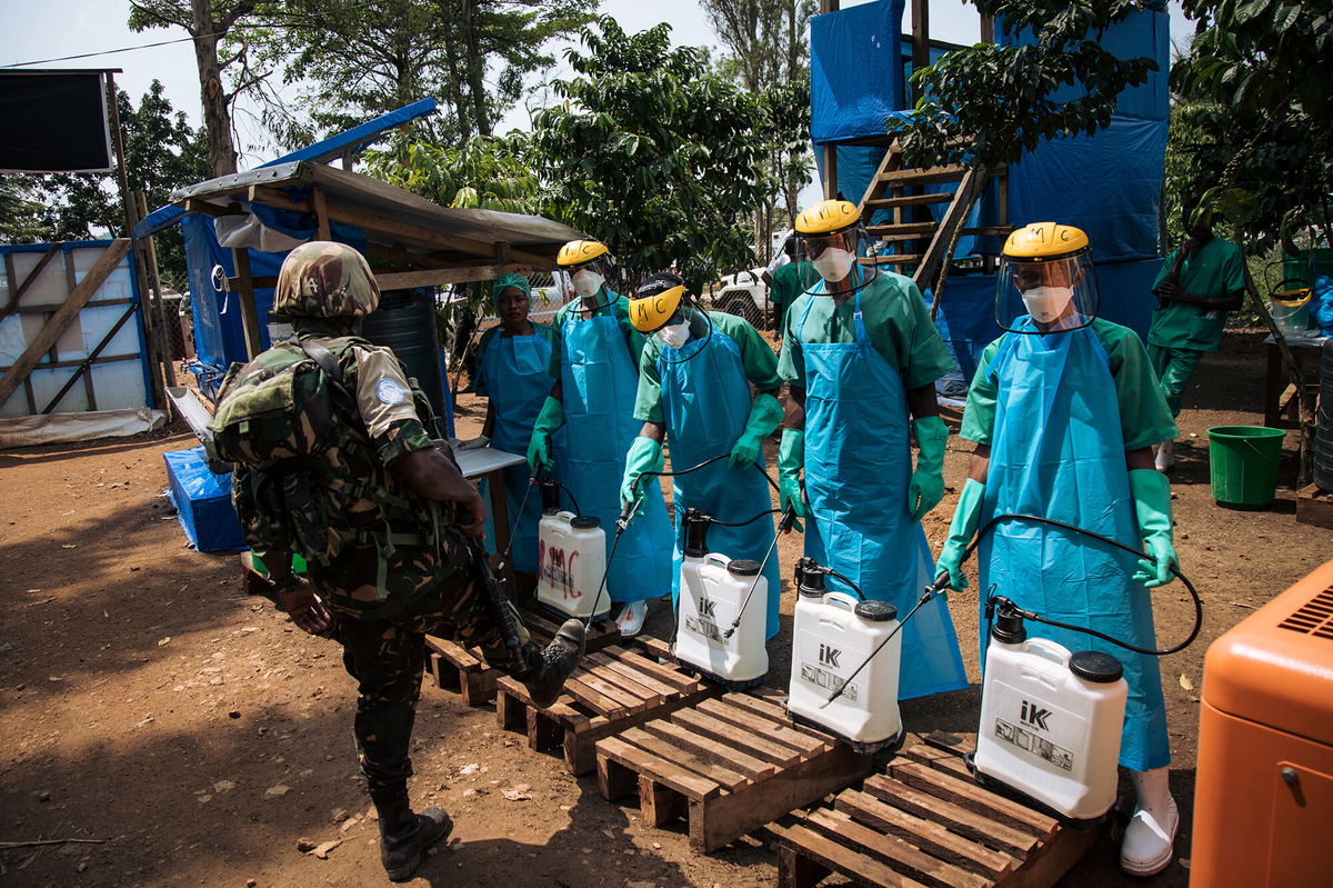 <i>Alexis Huguet/AFP/Getty Images</i><br/>A United Nations peacekeeper has his shoes cleaned with a chlorine solution before leaving an Ebola treatment centre in Mangina