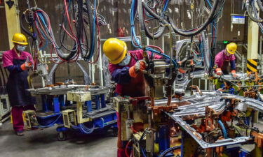 Workers assemble vehicles at a factory in Qingzhou